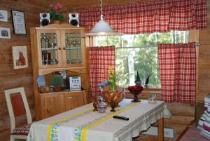 a table in a room with a red and white curtain at Kytötupa in Keuruu