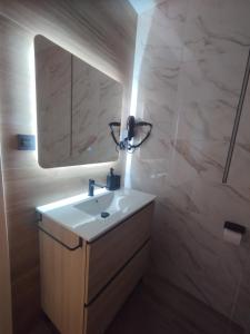 a bathroom with a white sink and a mirror at Casa Anton in Muxia +39 photos