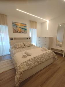 a bedroom with a large bed and a dresser at Casa Anton in Muxia