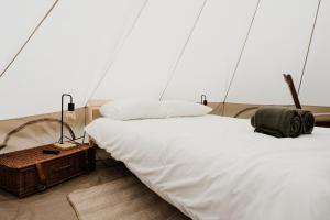 a bedroom with two beds in a tent at Luxe Glamping Tent in West-Friesland in Venhuizen