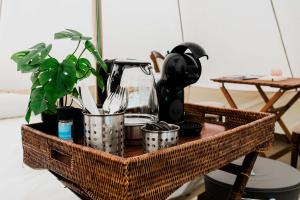 a wicker basket with utensils and a blender at Luxe Glamping Tent in West-Friesland in Venhuizen