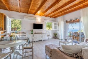 a living room with a couch and a table at Euterpe's house CORFU in Barbati