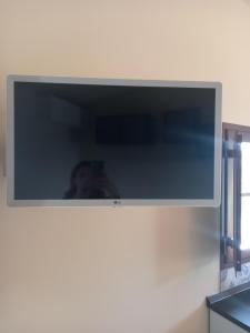 a flat screen tv hanging on a wall at TUSCANY SUNSET'S ROOM in Capannoli