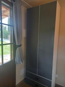 a large gray cabinet in a room with a window at TUSCANY SUNSET'S ROOM in Capannoli +20 photos