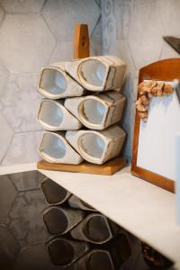 a shelf with a stack of plates and a mirror at Luxury House in Green Appia Antica in Rome