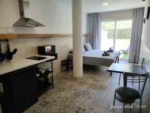 a room with a bed and a kitchen with a table at Apartamentos La Ruta in Calpe