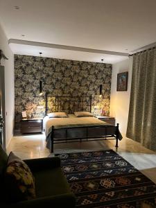 a bedroom with a large bed and a couch at Balkonum Luxury Guest House in Gosh