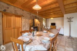 a dining room with a table and chairs at Goulapie, Village de gîtes in Saint-Quentin-sur-Sauxillanges