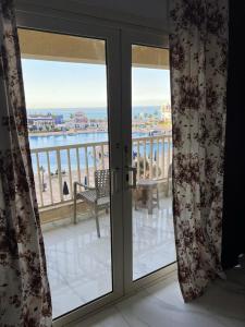 a view of the ocean from a room with sliding glass doors at بورتو السخنه -Hotel Porto vib in Ain Sokhna