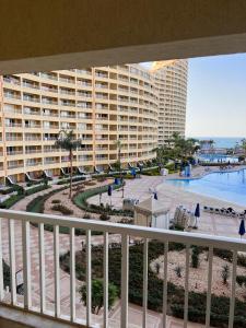 a balcony of a large apartment building with a pool at بورتو السخنه -Hotel Porto vib in Ain Sokhna