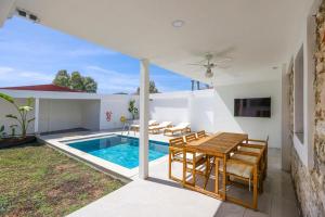 a villa with a swimming pool and a table and chairs at Traditional Seaside Stone Villa with Private Pool in Bodrum City