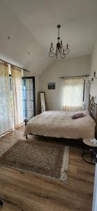 a bedroom with a large bed and a chandelier at Balkonum Luxury Guest House in Gosh