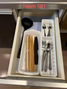 a drawer filled with utensils in a refrigerator at SkyHotel Ryogoku 駅徒歩4分 in Tokyo