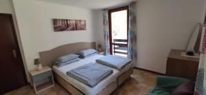 a bedroom with a bed with two pillows on it at Casa Galet in Pieve Di Ledro