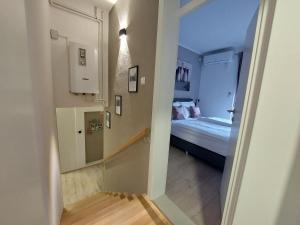 a hallway leading to a bedroom with a bed at Apartment Fery in Mostar