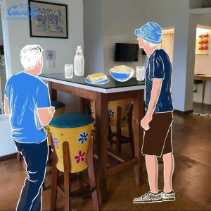 Dwóch mężczyzn stoi przy stole ze stołem w obiekcie Cavala The Seaside Resort w mieście Baga