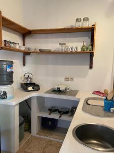 a kitchen with a sink and a counter top at Elephant House and Bungalows Gili Air in Gili Air