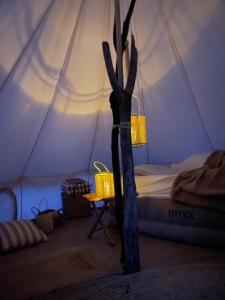 a bedroom with a tent with a bed and a table at Cozy Garden Glamping in Svendborg