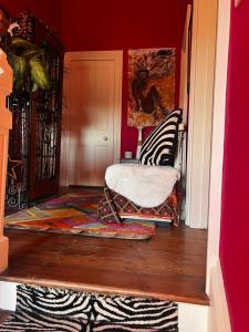 a room with two chairs and a rug on a floor at Belmont House Boutique - the Kingsley collection in Berwick-Upon-Tweed