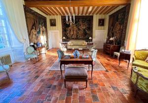sala de estar amplia con mesa y sillas en Château de Cadouzan, en Saint-Dolay