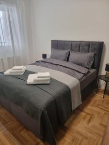 a bedroom with a bed with two towels on it at Apartment M in Smederevo