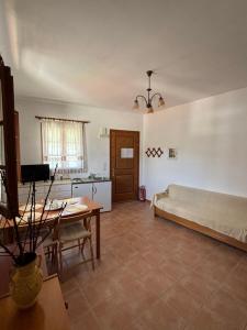 a living room with a couch and a table at Sofia’s Studio in Arnítha