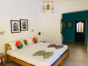 a bedroom with two beds with flowers on them at Cavala The Seaside Resort in Baga