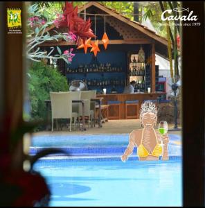 una mujer en una piscina con una copa de vino en Cavala The Seaside Resort en Baga