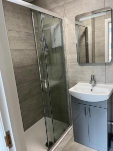 a bathroom with a shower and a sink at 1 bedroom ground floor apartment in Southbourne