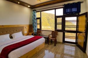 a bedroom with a bed and a large window at Goroomgo Grand Kailash View Home Stay Himachal pradesh in Khajjiar 
