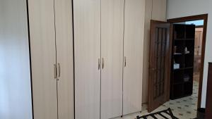 a room with white cabinets and a door with a mirror at Villa Sergio in Pero