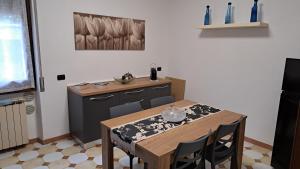 a kitchen with a table with chairs and a sink at Villa Sergio in Pero