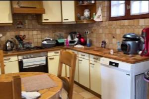 a kitchen with a table and a counter top at Belle maison sur Val de Loire in Channay-sur-Lathan