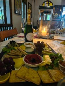 a table with a bottle of wine and a plate of food at Cavala The Seaside Resort, Baga in Baga