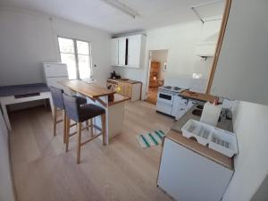 a kitchen with a table and chairs in a room at Schwedisches Bauernhaus in Jörn
