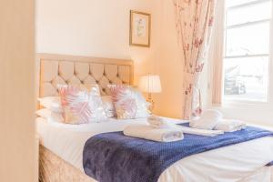 a bedroom with a bed with two towels on it at Rayrigg Villa at Windermere in Windermere