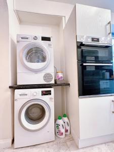 a laundry room with a washing machine and a microwave at Rayrigg Villa at Windermere in Windermere