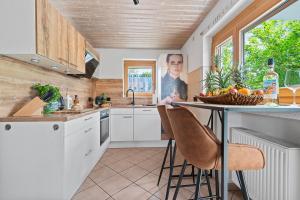 a kitchen with a table with a bowl of fruit on it at Industrial Loft am Pfaffenberg in Oberteuringen