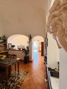 a kitchen and a dining room with a table at La dimora degli Dei in Praiano