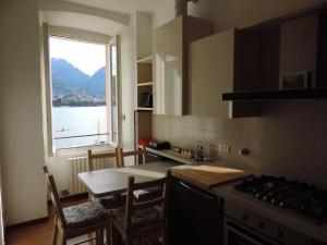 a kitchen with a view of the water and a window at Lungolago Malgrate in Malgrate