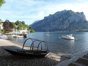 a boat sitting on the shore of a body of water at Lungolago Malgrate in Malgrate