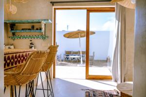 a dining room with a table and chairs and an open door at Villa Madame Babouche, Studio Lahna, SdB privative in Oulad el Madani