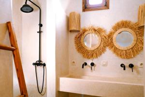 a bathroom with two mirrors and a sink at Villa Madame Babouche, Studio Lahna, SdB privative in Oulad el Madani