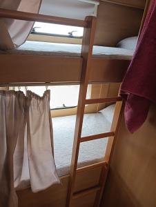 sypialnia z łóżkiem piętrowym i oknem w obiekcie Caravana Magic w mieście Tindaya