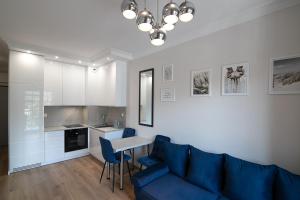 a living room with a blue couch and a table at Apartament2 Bulwar Staromiejski Stare Miasto Centrum in Wrocław +27 photos