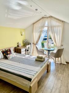 a bedroom with a large bed and a table and chairs at Simono Vila in Palanga