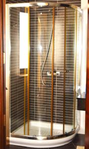 a shower with a glass door in a bathroom at Gmiel in-Natura B&B in Għajn il-Kbira