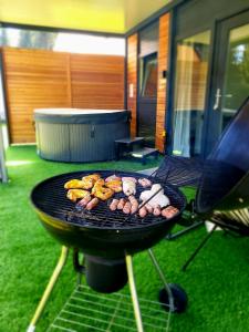 a grill with many different types of food on it at Resort na jasi in Zreče