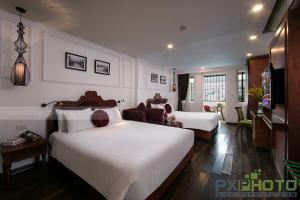 Postel nebo postele na pokoji v ubytování Vision Premier Hotel in Hanoi Central