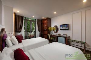 Postel nebo postele na pokoji v ubytování Vision Premier Hotel in Hanoi Central